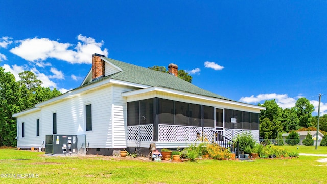 back of house featuring a sunroom and a yard