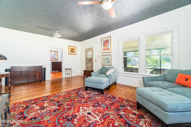 living room featuring ceiling fan and hardwood / wood-style flooring