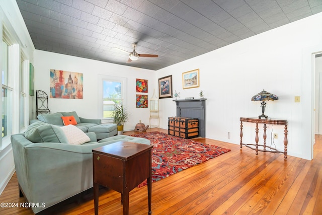 living room with ceiling fan and hardwood / wood-style flooring