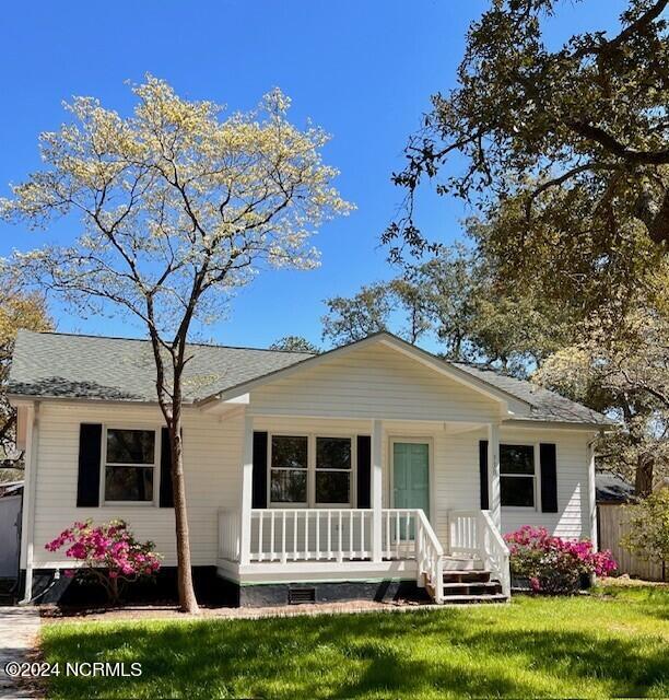 view of front of house with a front lawn and a porch