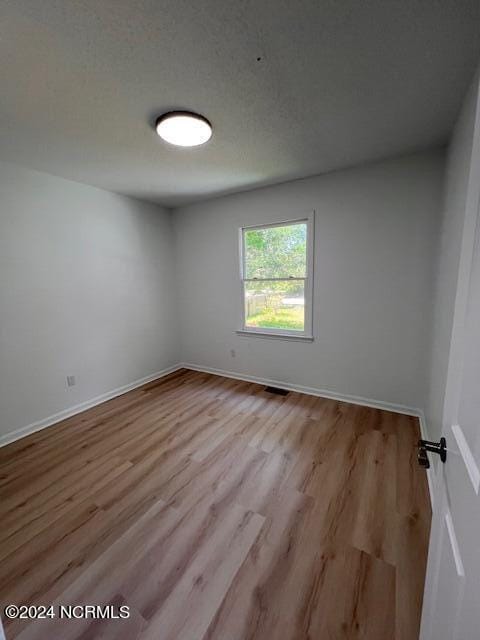 spare room featuring hardwood / wood-style floors