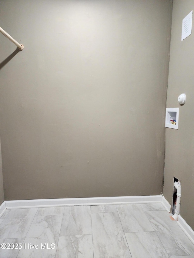 washroom featuring baseboards, marble finish floor, hookup for a washing machine, and laundry area