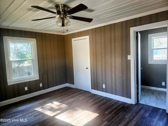 unfurnished bedroom with baseboards, dark wood-style flooring, and ceiling fan