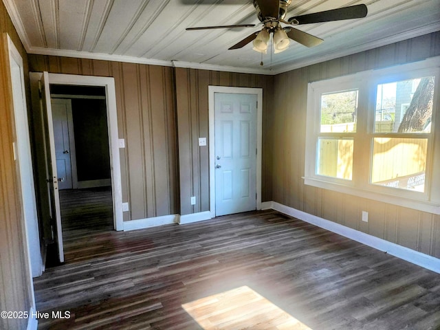 unfurnished bedroom with baseboards, ornamental molding, and dark wood-style flooring