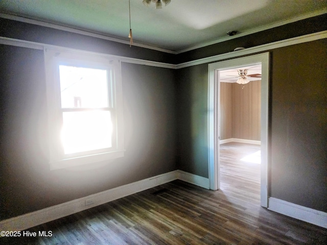 unfurnished room with baseboards and dark wood-style flooring