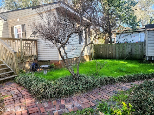 view of yard with a wooden deck and fence