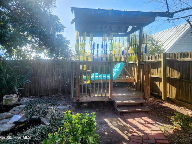 wooden terrace featuring a fenced backyard