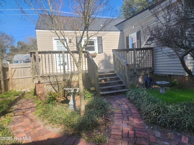 rear view of property with fence