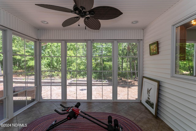 unfurnished sunroom featuring ceiling fan