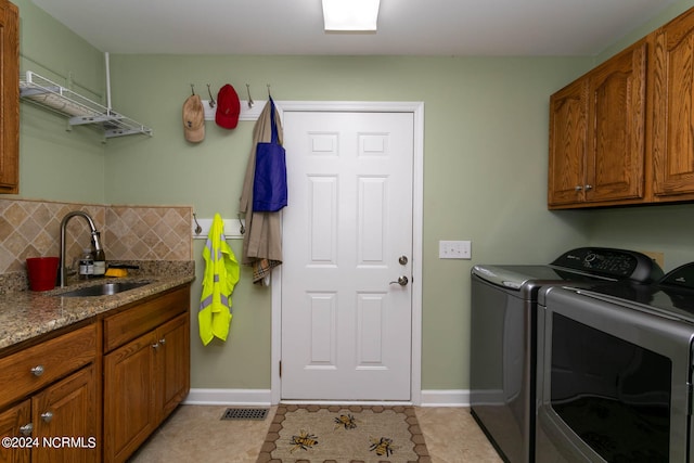 laundry room featuring sink, separate washer and dryer, cabinets, and light tile floors