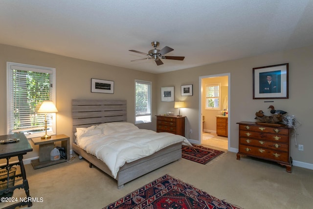 bedroom featuring connected bathroom, carpet flooring, ceiling fan, and a textured ceiling