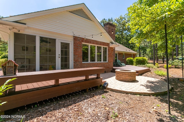 deck with a patio area and an outdoor fire pit