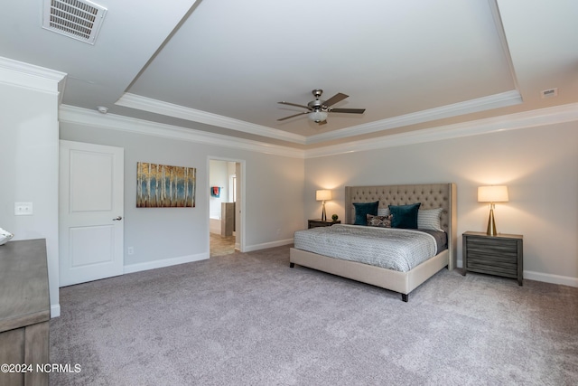 bedroom featuring light carpet, a tray ceiling, ceiling fan, and crown molding