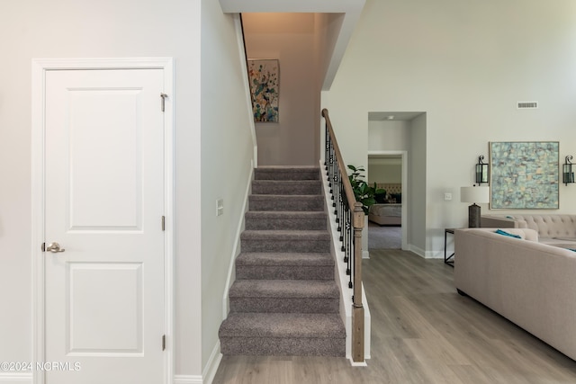 office with a chandelier, light hardwood / wood-style floors, a raised ceiling, and crown molding