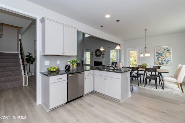 kitchen featuring plenty of natural light, white cabinets, pendant lighting, and appliances with stainless steel finishes