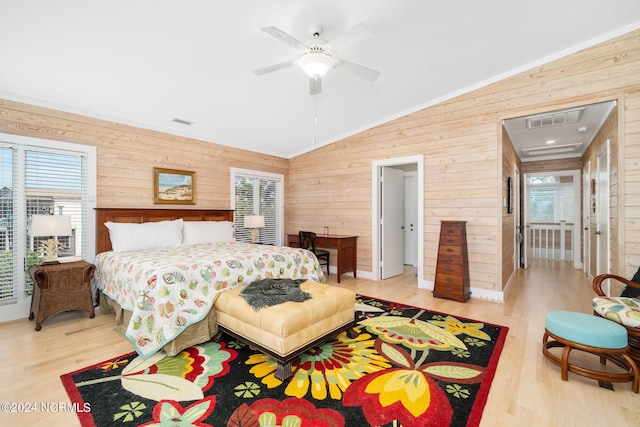 bedroom featuring multiple windows, ceiling fan, hardwood / wood-style floors, and vaulted ceiling