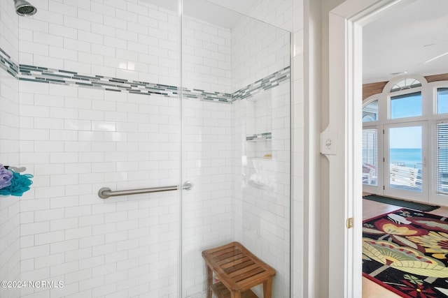 bathroom featuring an enclosed shower and a water view