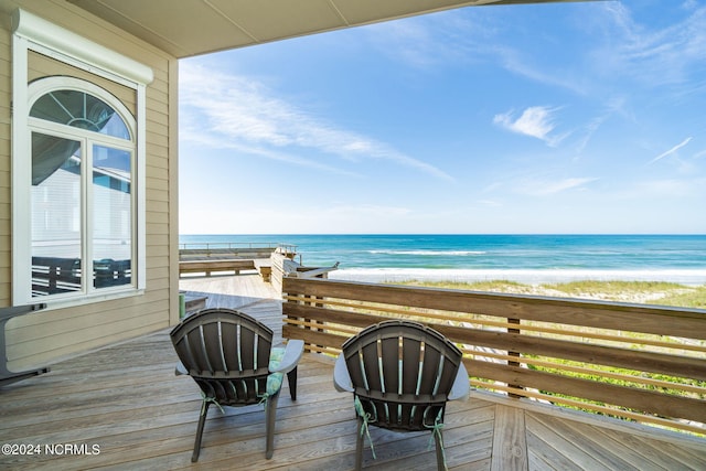 wooden terrace with a beach view and a water view