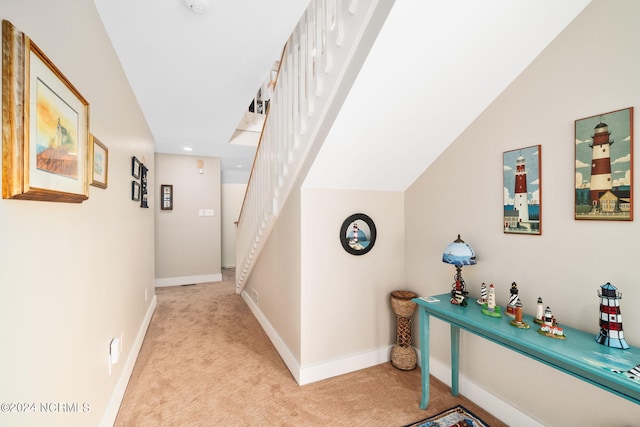 hallway featuring light carpet