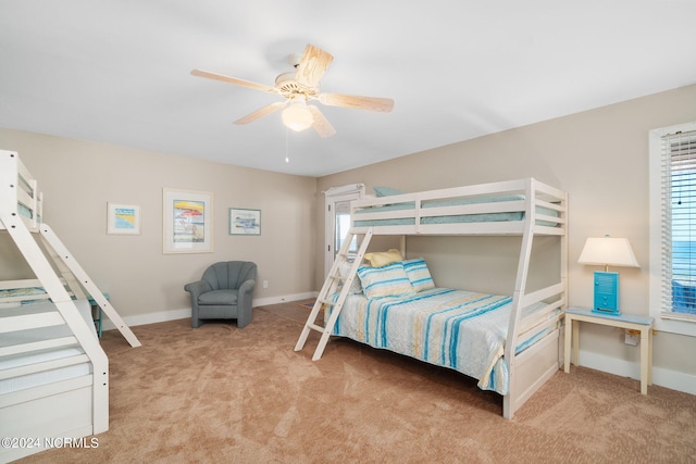 bedroom featuring light colored carpet and ceiling fan