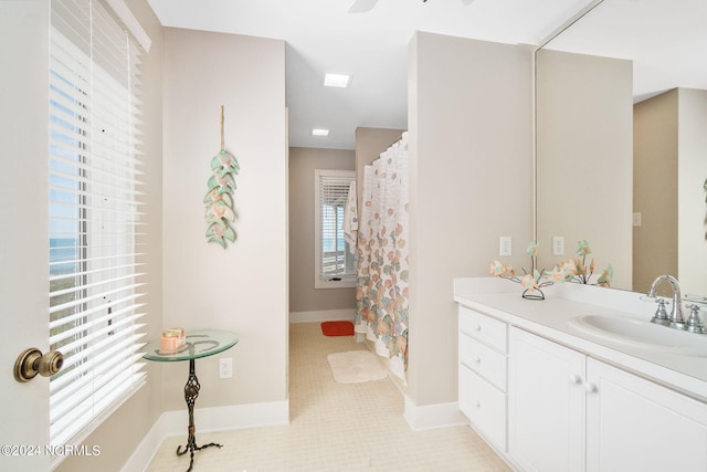 bathroom with tile patterned floors, vanity, ceiling fan, and a shower with shower curtain