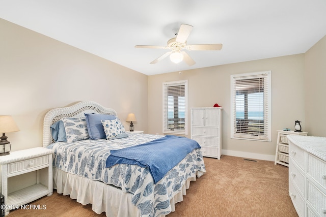 bedroom with ceiling fan and light carpet