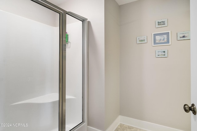 bathroom featuring a shower with door and tile patterned flooring