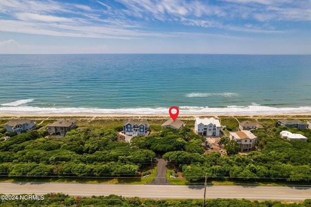 drone / aerial view with a water view and a beach view