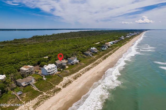 drone / aerial view featuring a water view and a beach view