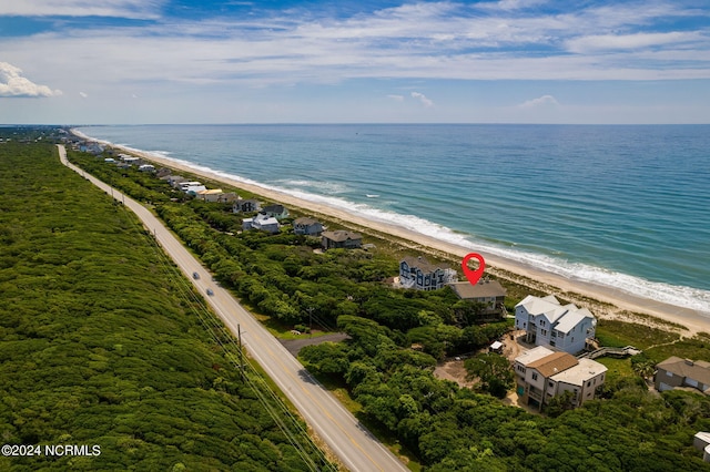 birds eye view of property featuring a view of the beach and a water view