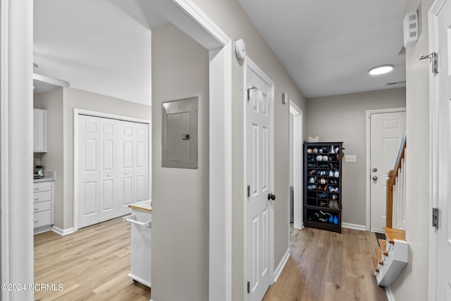 hall with electric panel and light hardwood / wood-style floors