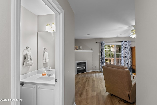 bathroom with vanity, ceiling fan, and wood-type flooring