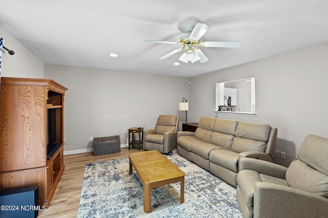 living room featuring light hardwood / wood-style flooring and ceiling fan