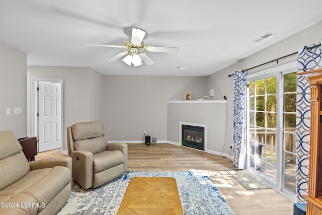 living room featuring hardwood / wood-style floors and ceiling fan