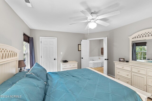 bathroom featuring vanity and a washtub