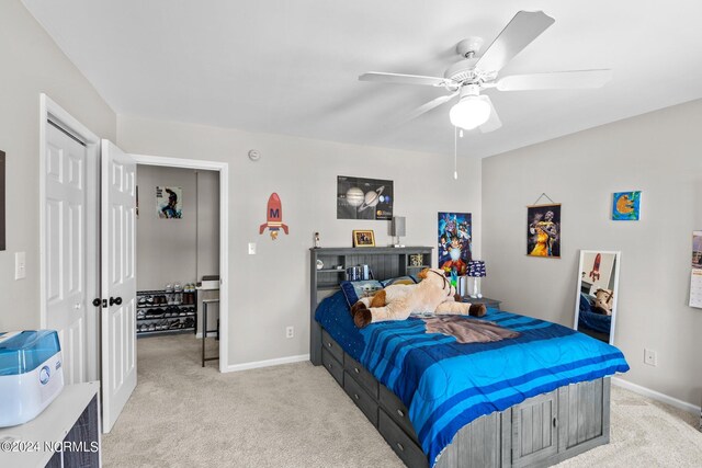 bedroom with light carpet and ceiling fan