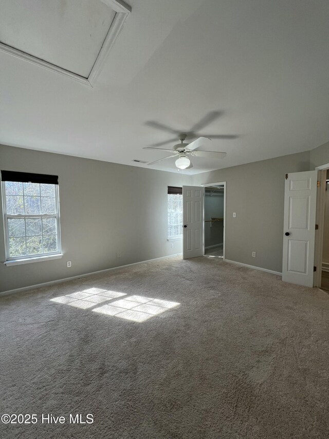 bathroom with a wealth of natural light, vanity, toilet, and an enclosed shower