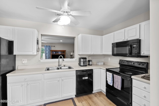 kitchen featuring white cabinets, ceiling fan, light hardwood / wood-style flooring, black appliances, and sink