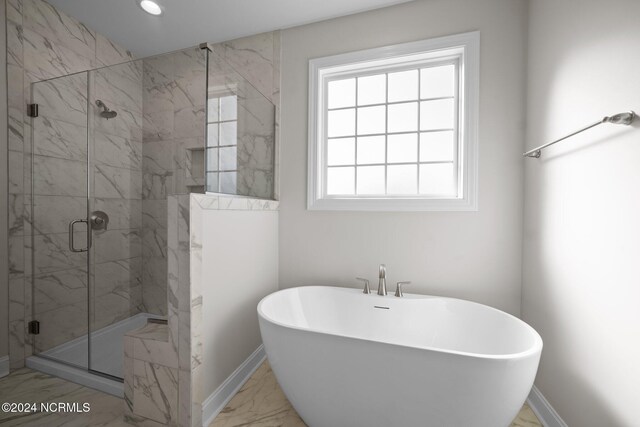 full bath featuring marble finish flooring, a freestanding bath, a marble finish shower, baseboards, and recessed lighting