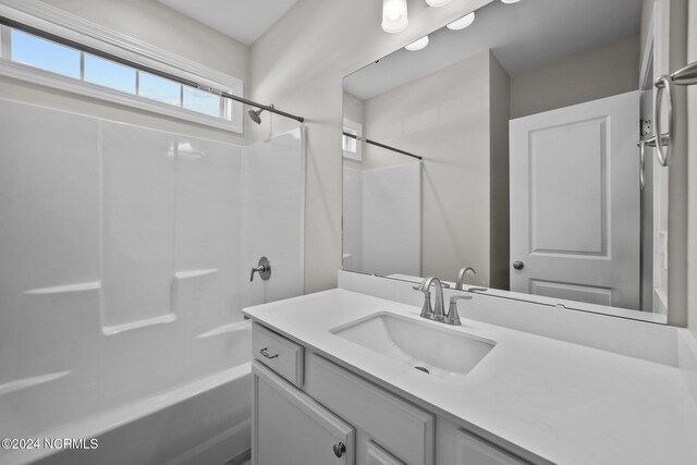 full bathroom featuring vanity and washtub / shower combination