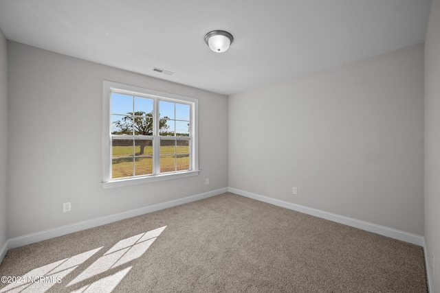 unfurnished room with carpet flooring and baseboards