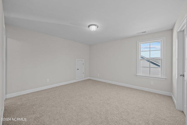 carpeted spare room with baseboards