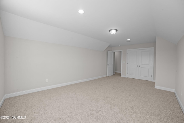 bonus room featuring lofted ceiling, light colored carpet, baseboards, and recessed lighting