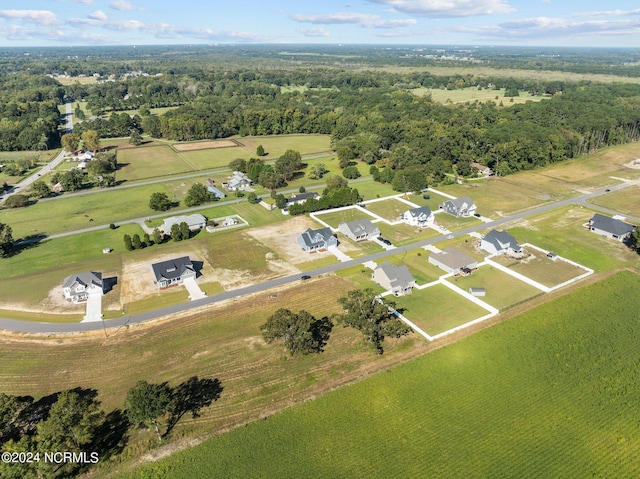 aerial view of property and surrounding area with a heavily wooded area