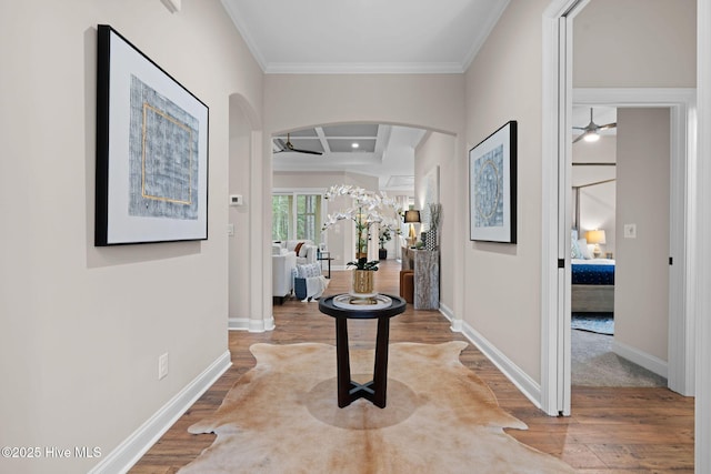 hall featuring hardwood / wood-style flooring, ornamental molding, coffered ceiling, and beam ceiling