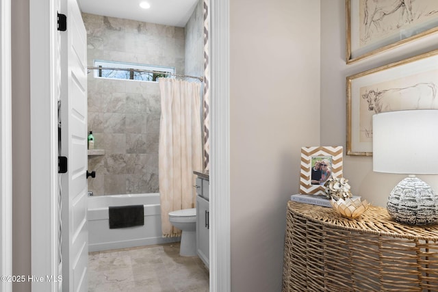 bathroom featuring shower / bath combination with curtain and toilet