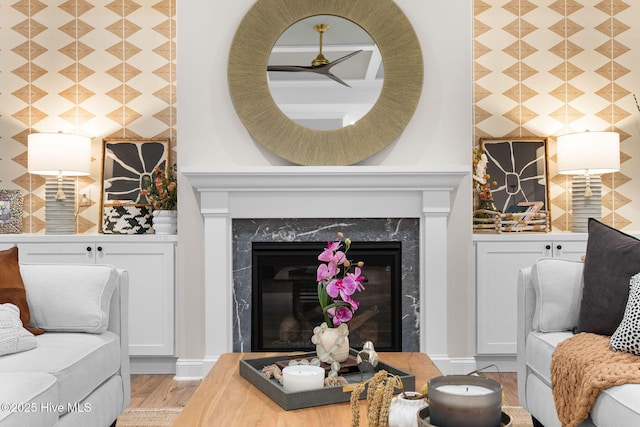 living room with light hardwood / wood-style flooring and a high end fireplace