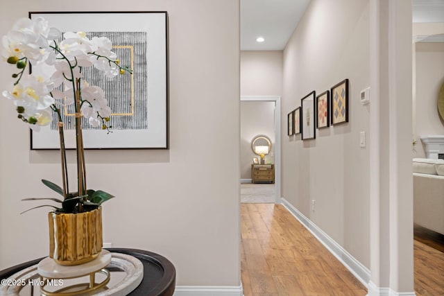 corridor with light hardwood / wood-style floors