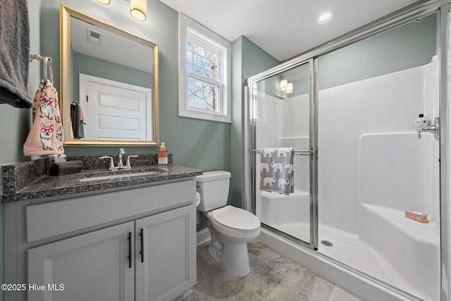 bathroom with vanity, toilet, and walk in shower