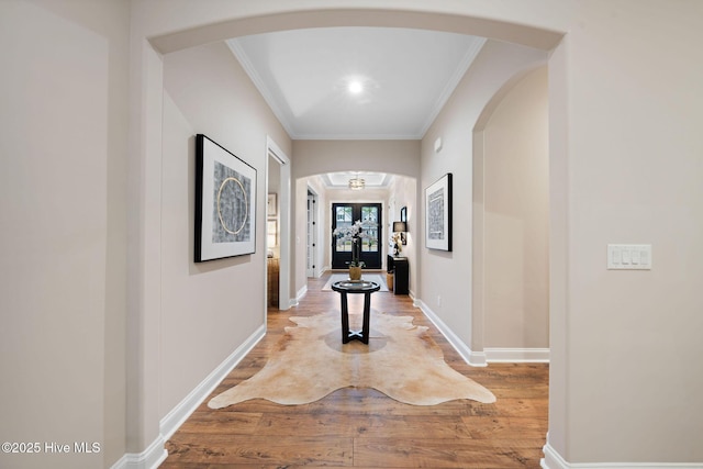 hall with hardwood / wood-style flooring and crown molding